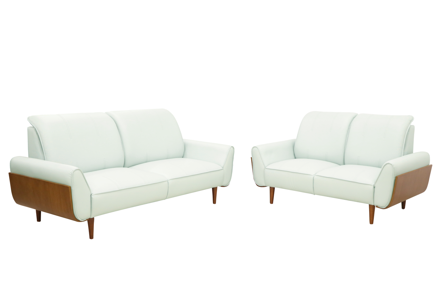 A pair of white leather sofas featuring wooden legs, set in a stylish interior.