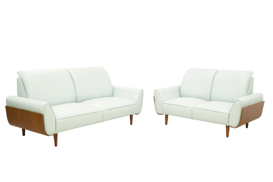 A pair of white leather sofas featuring wooden legs, set in a stylish interior.