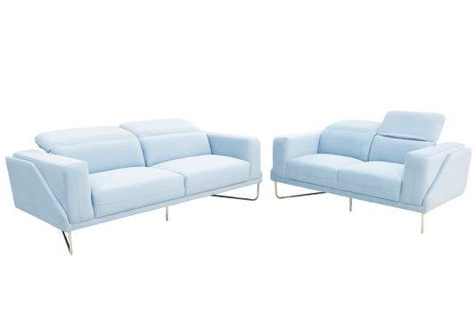 A light blue couch featuring two pillows, offering a comfortable and stylish addition to the living space.