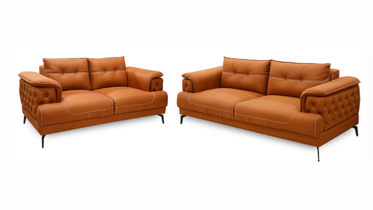  A pair of leather sofas featuring coordinated pillows and cushions, enhancing the comfort and aesthetic of the space.
